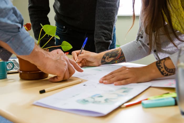 Image of design documents and hands on top reviewing them